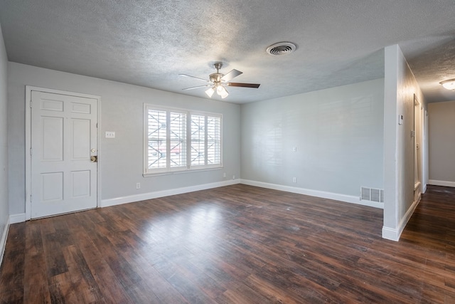 interior space with ceiling fan, dark hardwood / wood-style flooring, and a textured ceiling