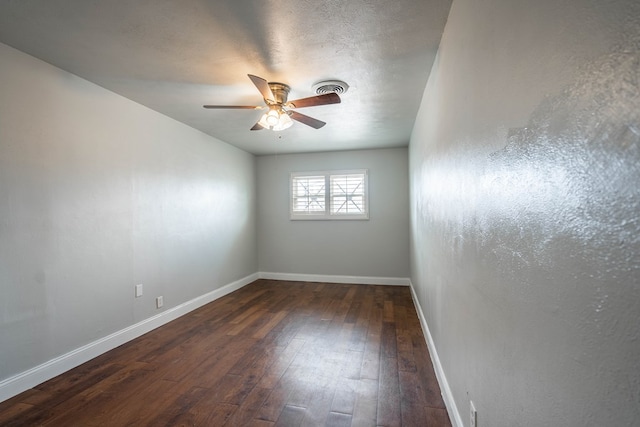 unfurnished room with ceiling fan, a textured ceiling, and dark hardwood / wood-style flooring