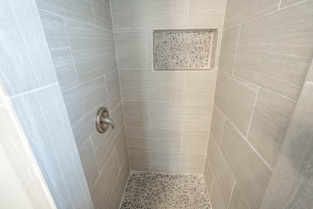 bathroom with tiled shower