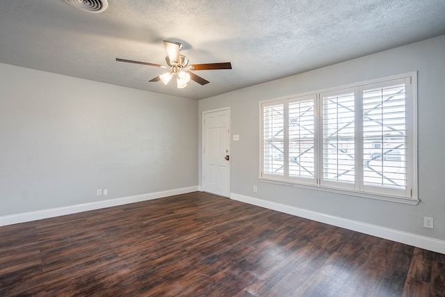 spare room featuring ceiling fan, dark hardwood / wood-style flooring, and a textured ceiling