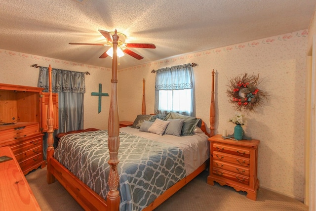 carpeted bedroom with wallpapered walls, a ceiling fan, and a textured ceiling