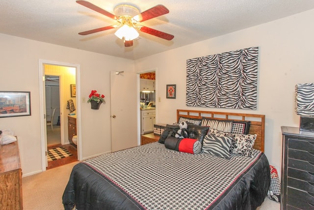 carpeted bedroom with connected bathroom, baseboards, a textured ceiling, and ceiling fan