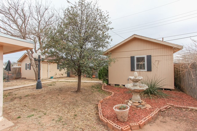 view of yard with an outbuilding and fence