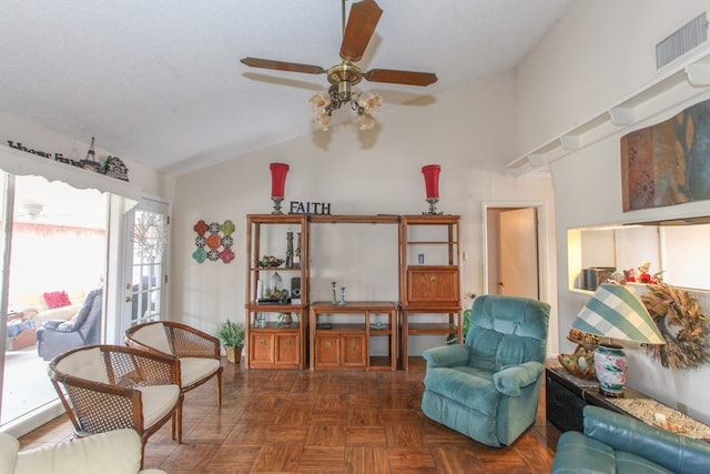 living room featuring lofted ceiling, a ceiling fan, and visible vents