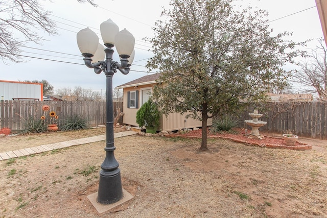 view of yard with an outdoor structure and fence private yard