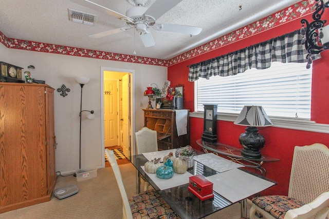 dining area featuring visible vents, a textured ceiling, ceiling fan, and carpet