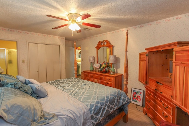 bedroom featuring visible vents, wallpapered walls, carpet flooring, a closet, and a textured ceiling