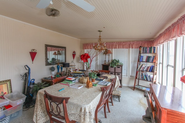 dining space with carpet and a chandelier