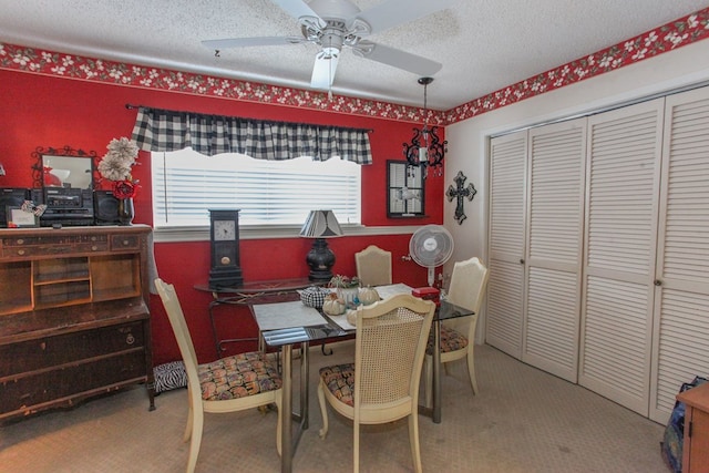 carpeted office space featuring a ceiling fan and a textured ceiling