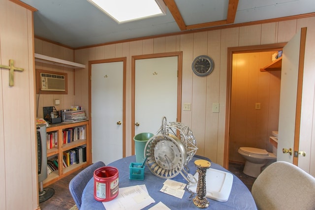 dining area with wood finished floors and a wall mounted AC