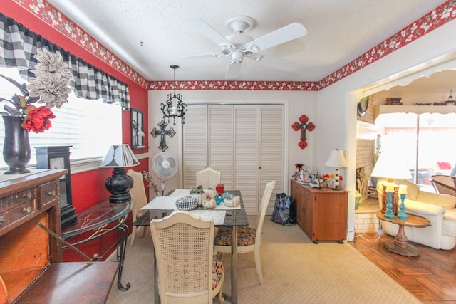 dining space with a textured ceiling and ceiling fan