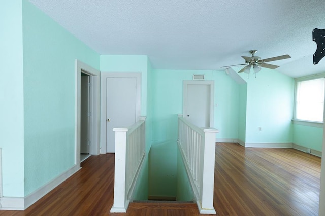 1001 W Walnut St, Coleman, TX 76834 - staircase with wood finished floors, a textured ceiling, and a ceiling fan