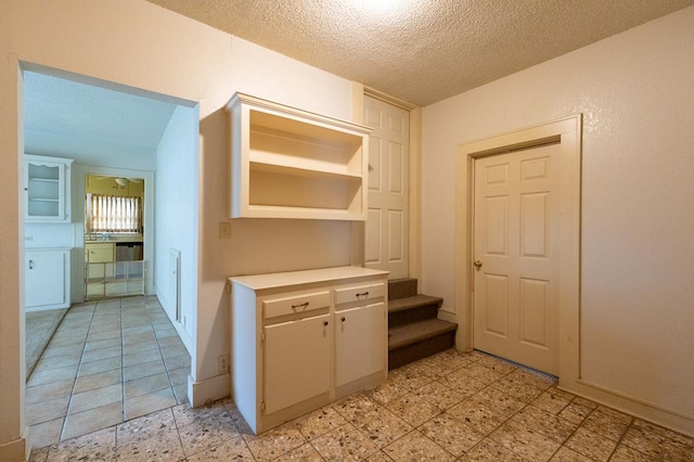 1001 W Walnut St, Coleman, TX 76834 - hallway with a textured ceiling and stairs