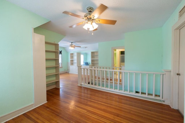 1001 W Walnut St, Coleman, TX 76834 - spare room featuring wood finished floors, a ceiling fan, and a textured ceiling