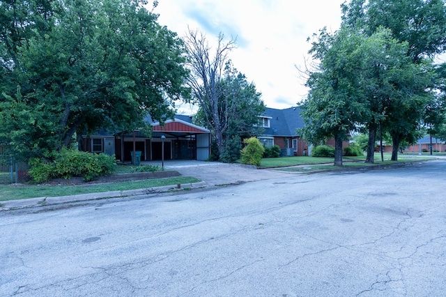 1001 W Walnut St, Coleman, TX 76834 - view of front of home with driveway and a carport
