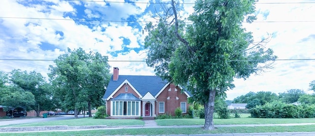 1001 W Walnut St, Coleman, TX 76834 - view of front facade with a front yard, a chimney, and brick siding