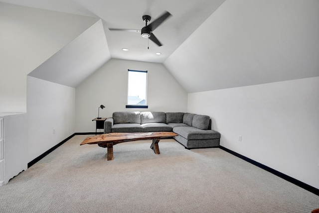 living area featuring lofted ceiling, ceiling fan, light colored carpet, and baseboards