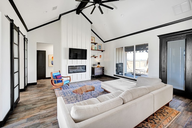 living area featuring a barn door, visible vents, a ceiling fan, dark wood-type flooring, and high vaulted ceiling