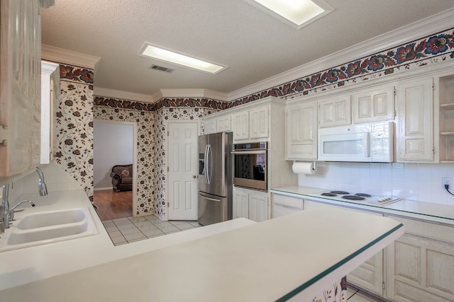 5411 Ridgemont Ct, Midland, TX 79707 - kitchen featuring appliances with stainless steel finishes, ornamental molding, wallpapered walls, a sink, and light countertops