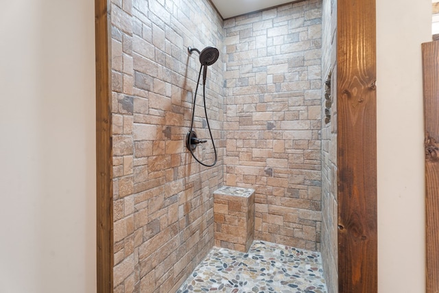 bathroom with a tile shower