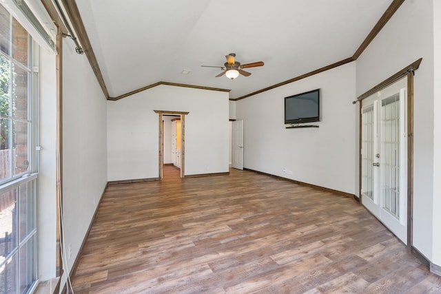 unfurnished living room featuring french doors, ornamental molding, vaulted ceiling, ceiling fan, and hardwood / wood-style floors