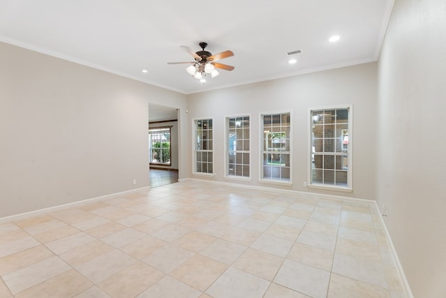 tiled spare room featuring ceiling fan and ornamental molding