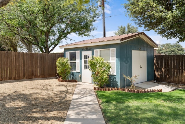 view of outbuilding with a yard