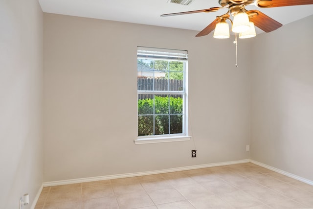 tiled spare room with ceiling fan