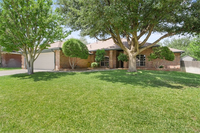 single story home featuring a front lawn and a garage