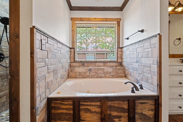 bathroom with a tub, vanity, and ornamental molding