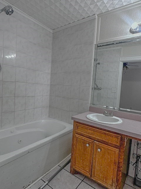 bathroom featuring vanity, crown molding, tile patterned flooring, ceiling fan, and tiled shower / bath combo