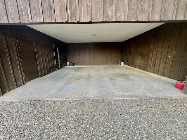 garage featuring wood walls