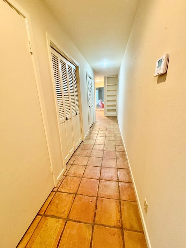 hall featuring light tile patterned floors