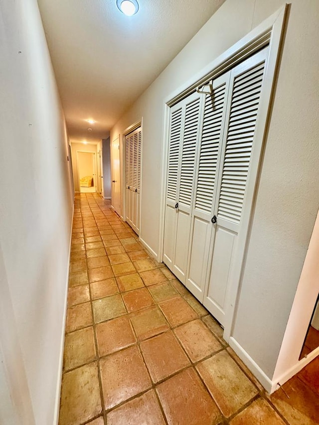 hall with light tile patterned flooring