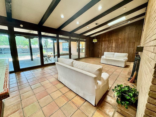 living room featuring wood walls and beam ceiling