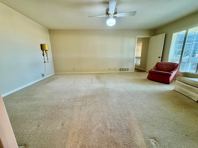 unfurnished living room featuring carpet flooring and ceiling fan