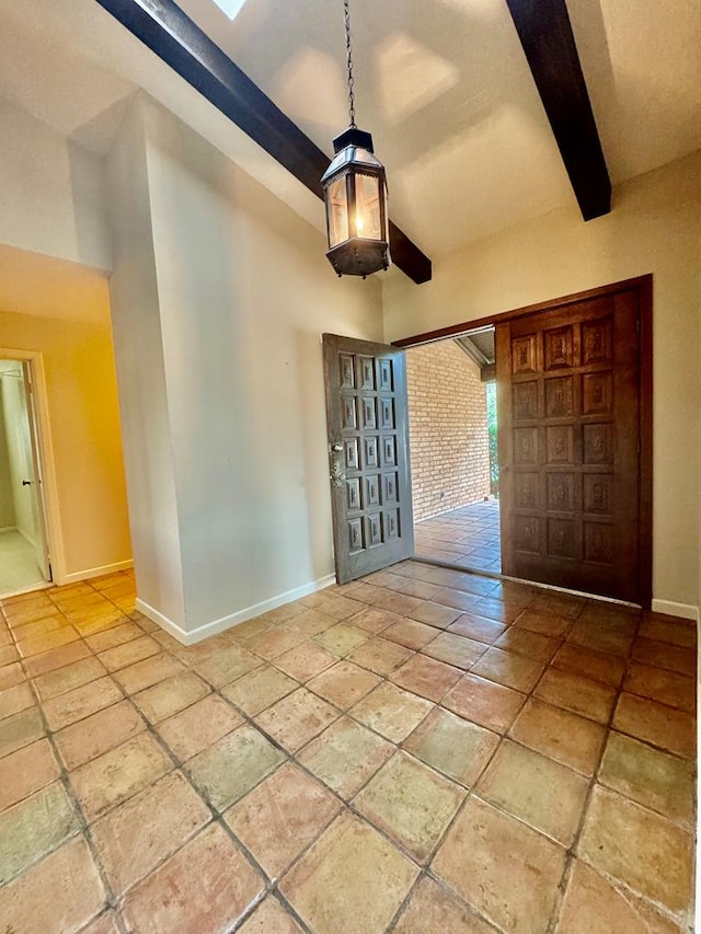 foyer entrance with beam ceiling and a towering ceiling