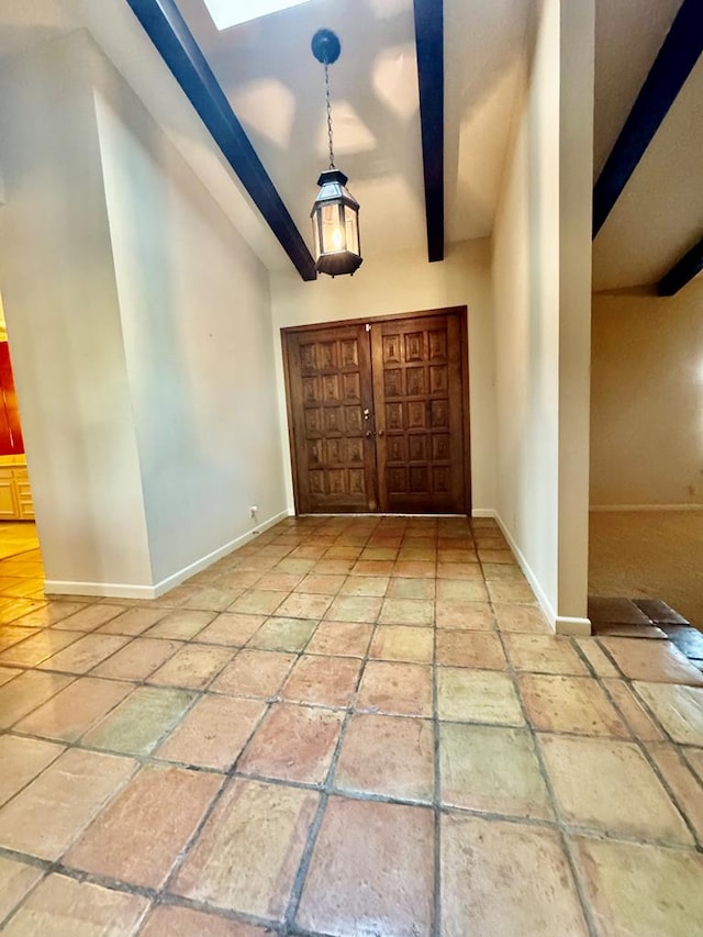 foyer entrance with beamed ceiling