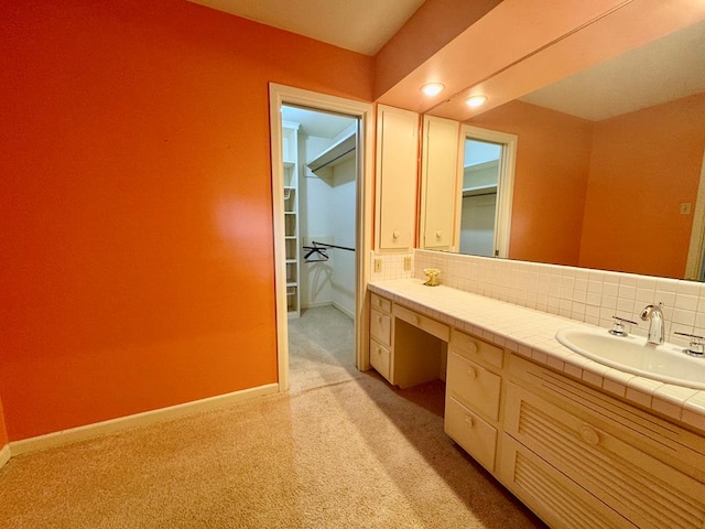 bathroom featuring decorative backsplash and vanity