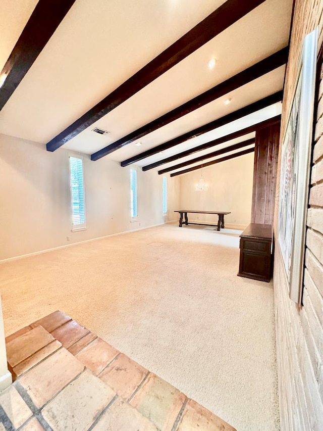 interior space featuring carpet flooring and an inviting chandelier