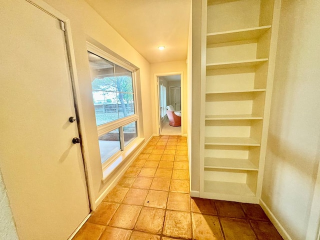 hall with light tile patterned flooring