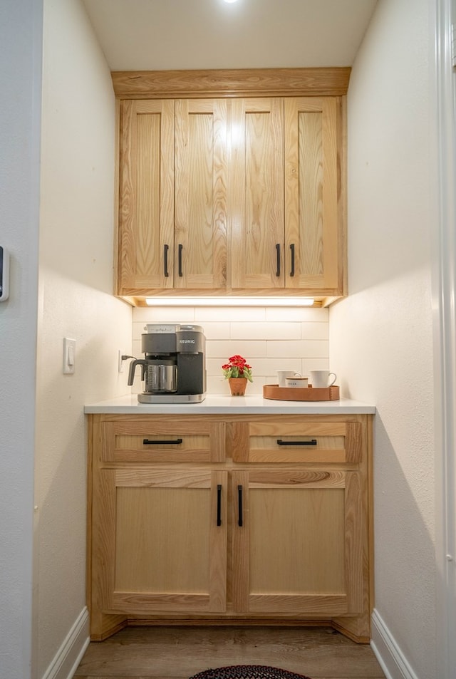 2223 S 2nd Pl, Lamesa, TX 79331 - bar with baseboards, tasteful backsplash, and wood finished floors