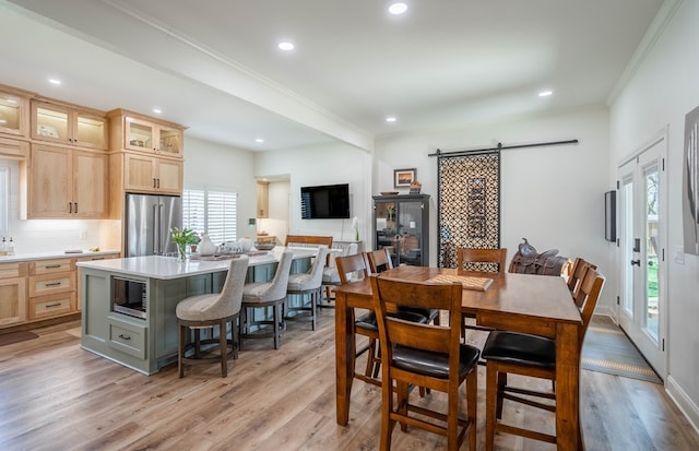 2223 S 2nd Pl, Lamesa, TX 79331 - dining space featuring recessed lighting, ornamental molding, baseboards, a barn door, and light wood finished floors