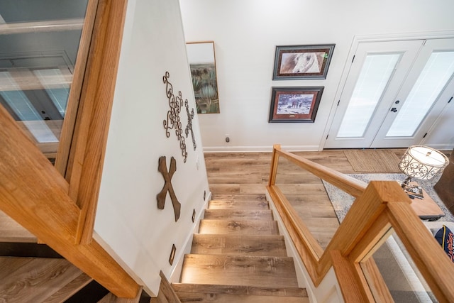2223 S 2nd Pl, Lamesa, TX 79331 - stairway featuring baseboards, wood finished floors, and french doors