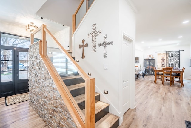 2223 S 2nd Pl, Lamesa, TX 79331 - stairway with french doors, recessed lighting, visible vents, and wood finished floors