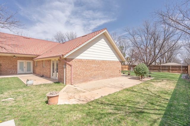 2223 S 2nd Pl, Lamesa, TX 79331 - back of house featuring a patio area, brick siding, fence, and french doors