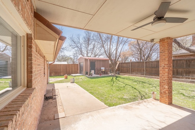 2223 S 2nd Pl, Lamesa, TX 79331 - view of yard featuring a patio area, a ceiling fan, an outdoor structure, a storage shed, and a fenced backyard