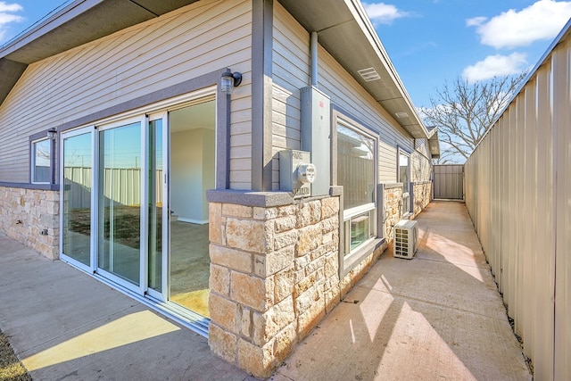 view of side of home featuring ac unit and a patio area