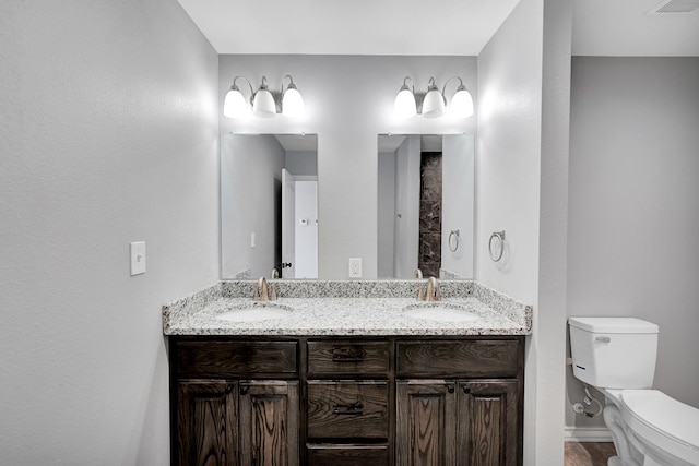 bathroom featuring toilet and vanity