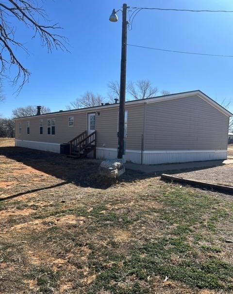 back of property featuring central air condition unit